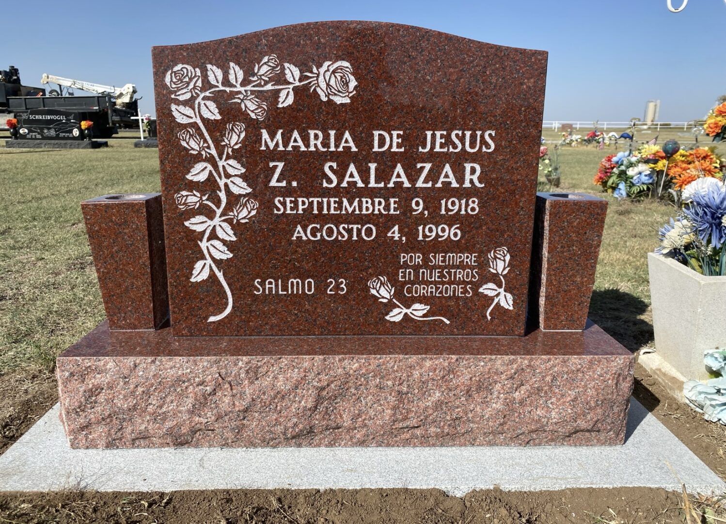 Cemetery headstone with floral designs