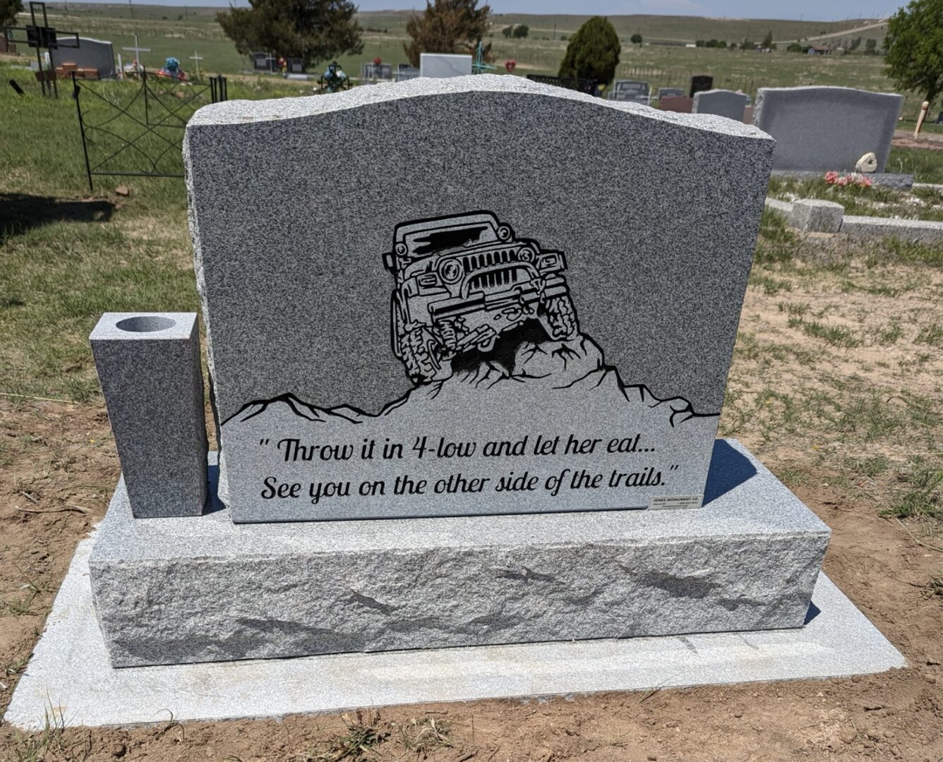 Gravestone with off-road vehicle engraving