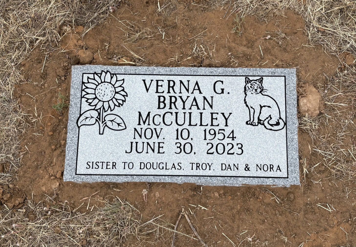 Gravestone with sunflower and cat engraving